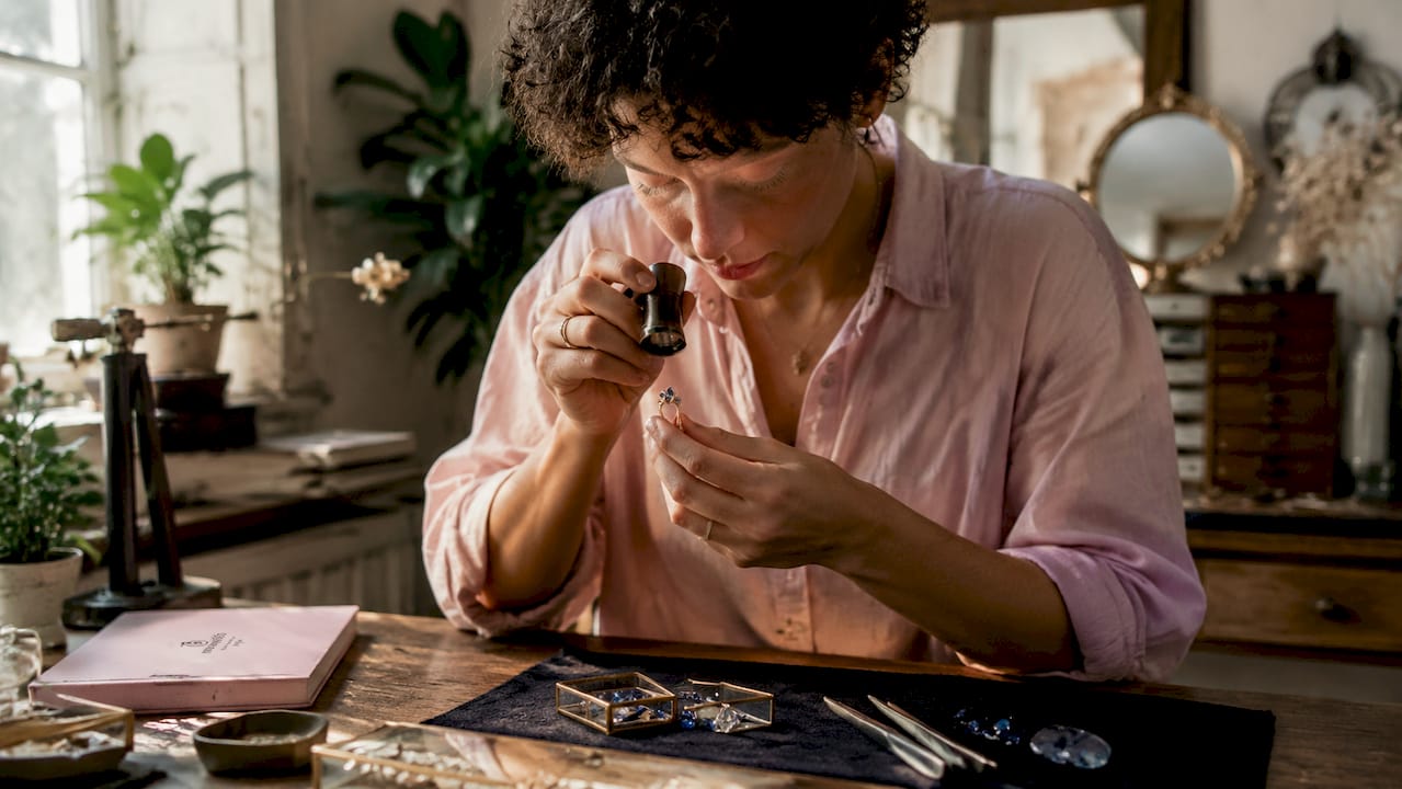 Jeweler examining multistone engagement ring close-up