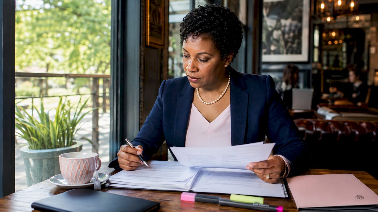 Businesswoman reviewing sourced procurement documents