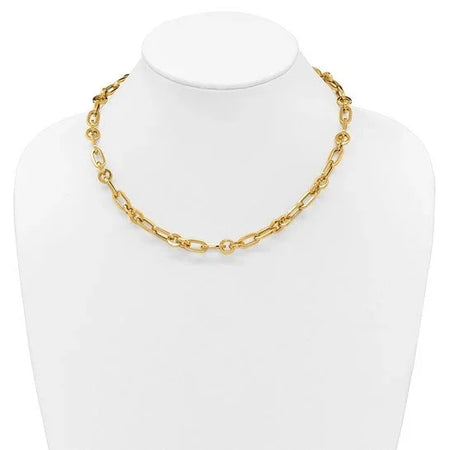 Gold chain link necklace displayed on a white jewelry bust