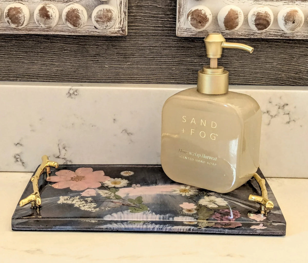 Stacy K Studio floral resin vanity tray with gold handles holding a soap dispenser