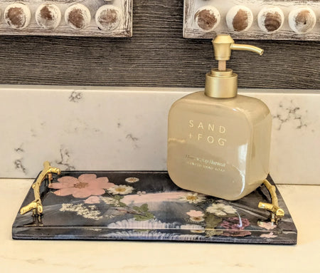 Stacy K Studio floral resin vanity tray with gold handles holding a soap dispenser