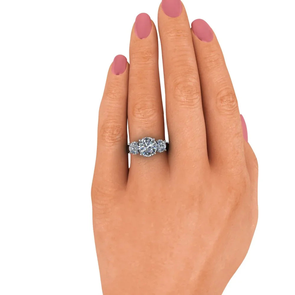 Hand wearing a custom diamond engagement ring with side stones on white background
