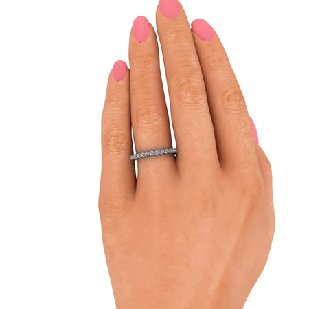 Diamond eternity band on hand with pink nail polish, custom wedding ring jewelry