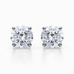 Round lab grown diamond stud earrings in white gold four-prong settings