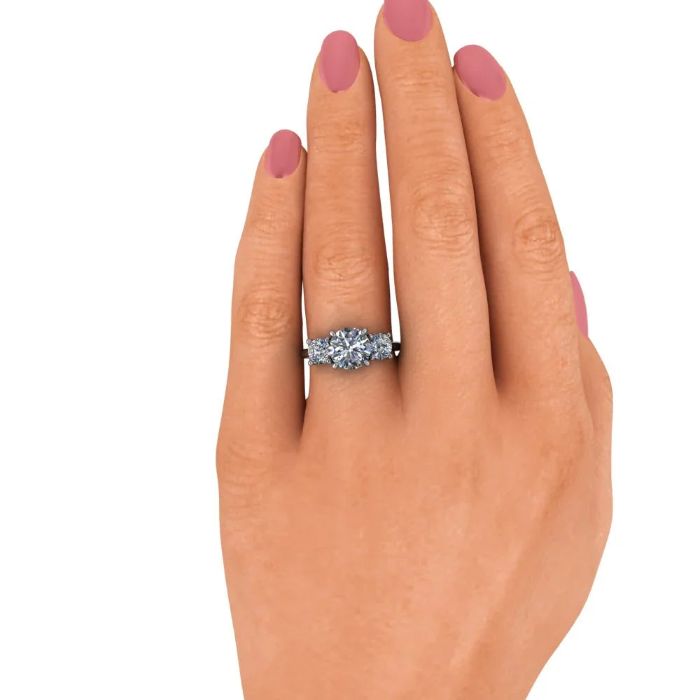 Hand wearing a diamond engagement ring with round center stone and side accents