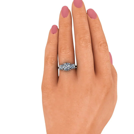 Hand wearing a diamond engagement ring with round center stone and side accents
