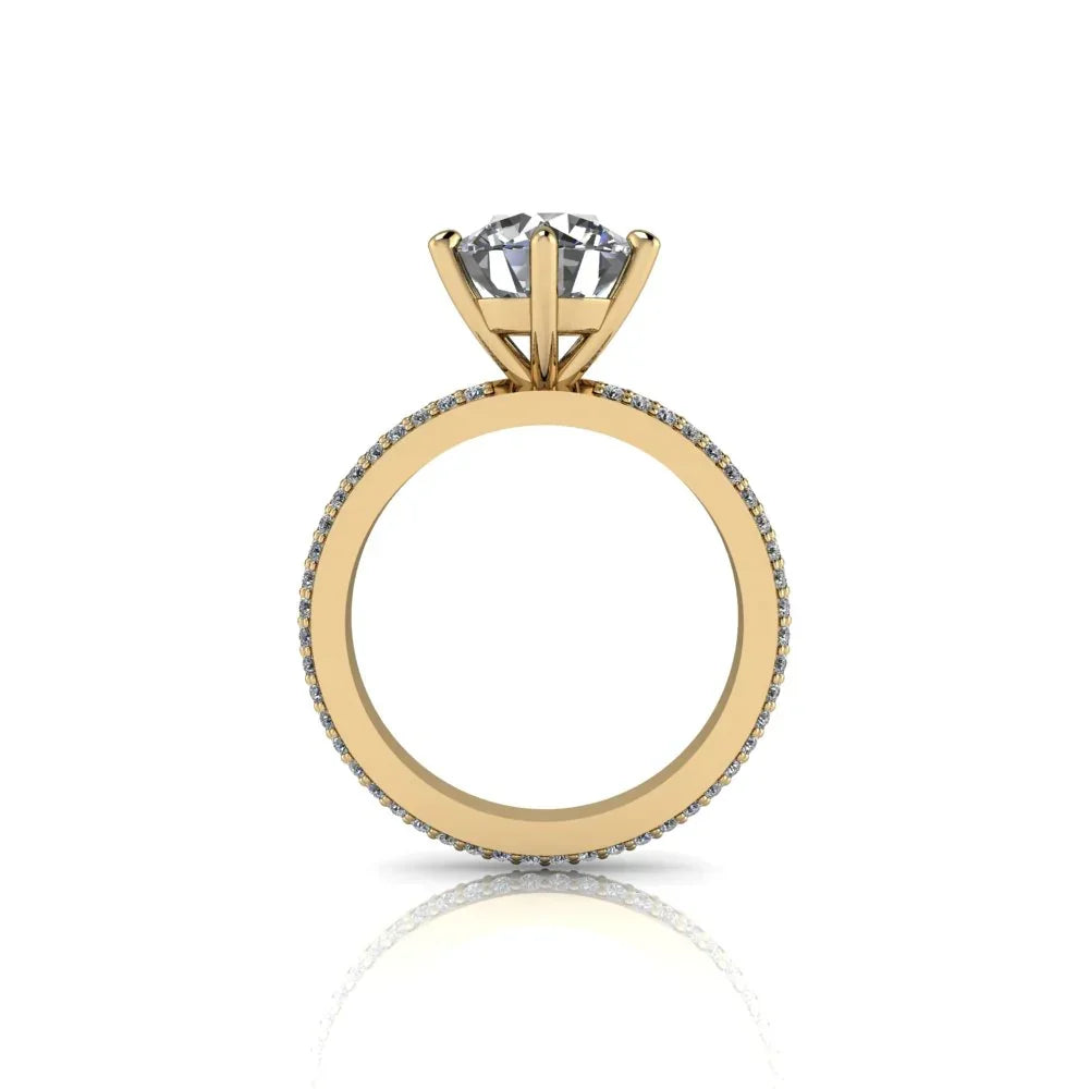 Yellow gold engagement ring with round diamond solitaire and pavé band, side view