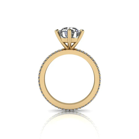 Yellow gold engagement ring with round diamond solitaire and pavé band, side view