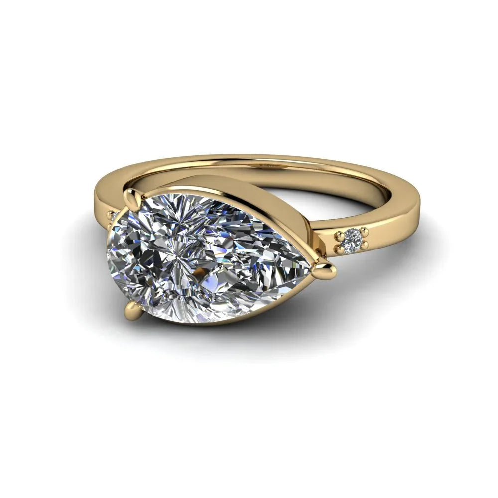 Pear-shaped diamond engagement ring in yellow gold with accent stones