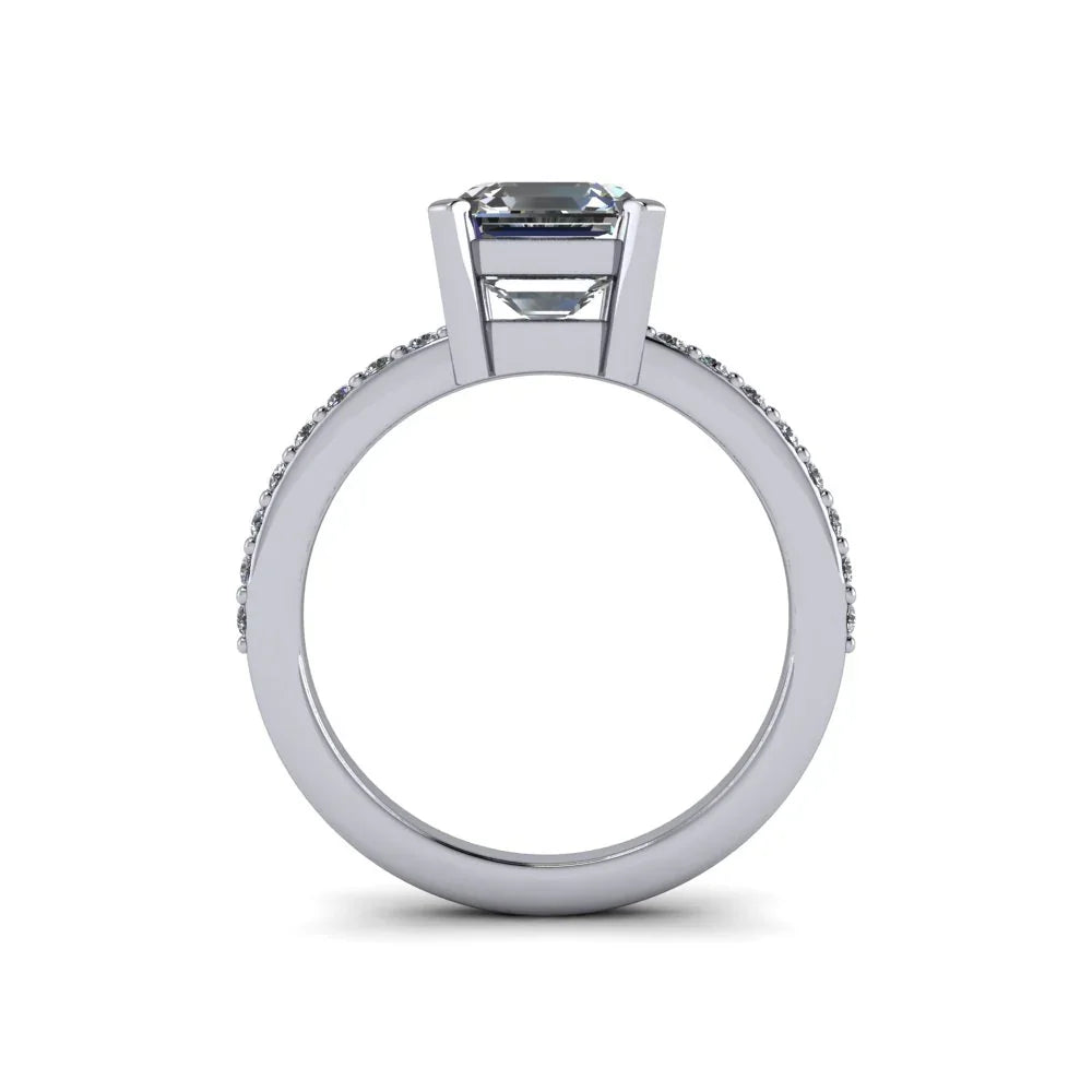 Side view of white gold custom engagement ring with emerald-cut center diamond and pavé band