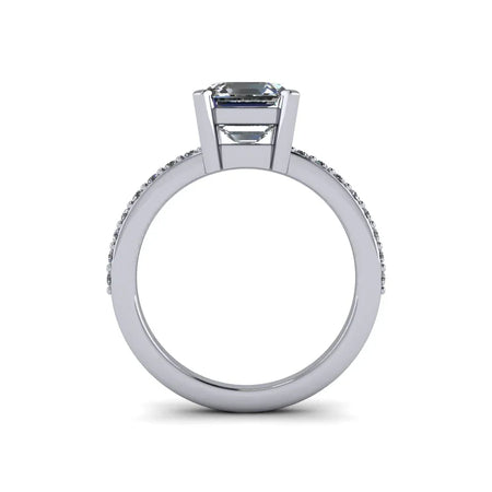 Side view of white gold custom engagement ring with emerald-cut center diamond and pavé band