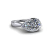 Pear-shaped diamond engagement ring with white gold band on white background