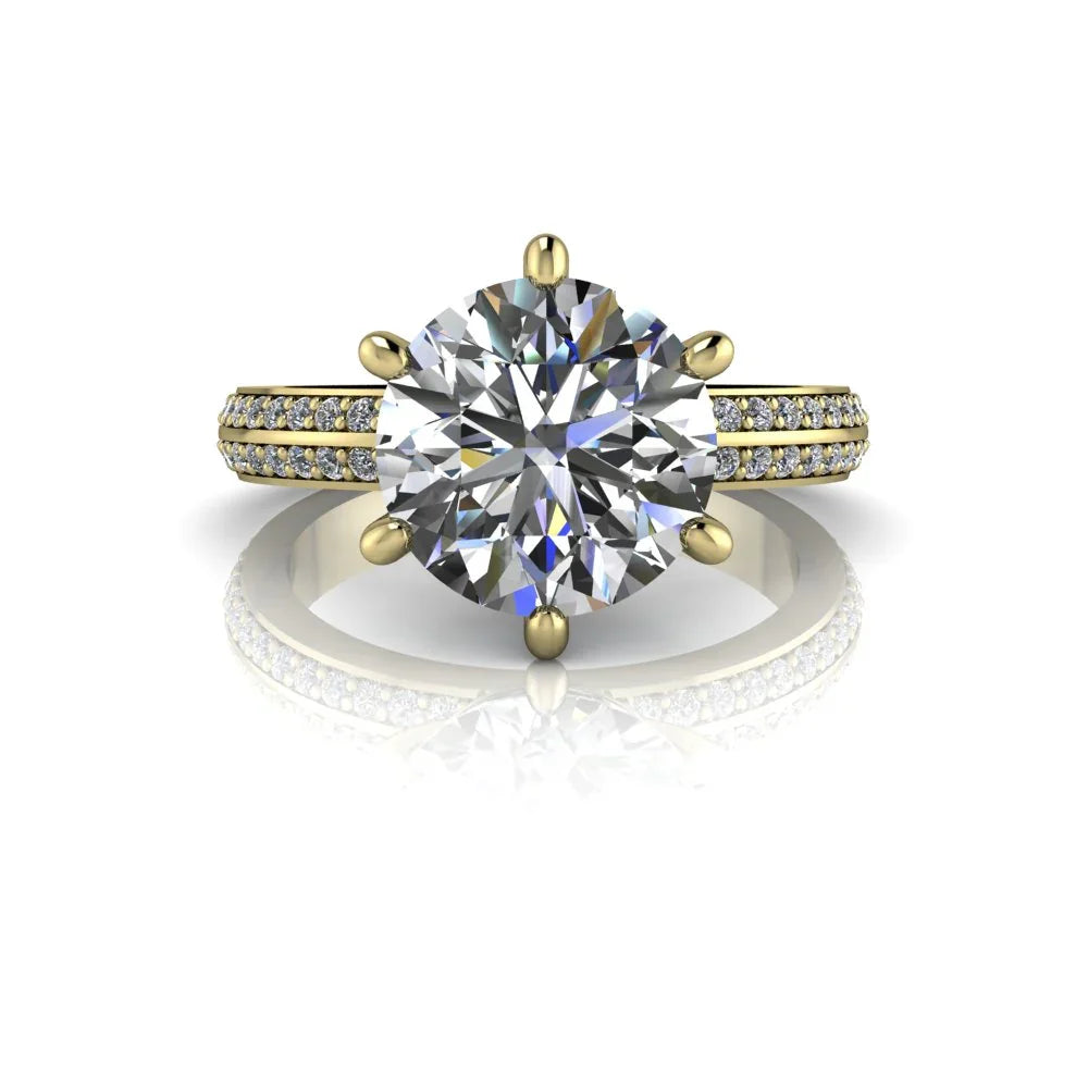 Yellow gold engagement ring with large round diamond and pavé diamond band on white background