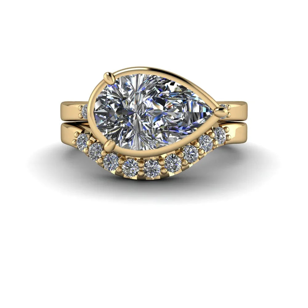 Yellow gold pear-shaped diamond engagement ring with matching diamond band