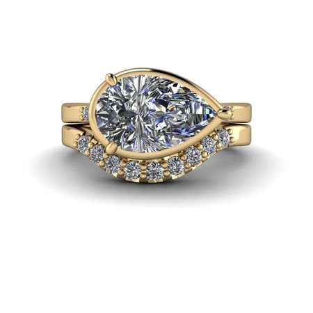 Yellow gold pear-shaped diamond engagement ring with matching diamond band