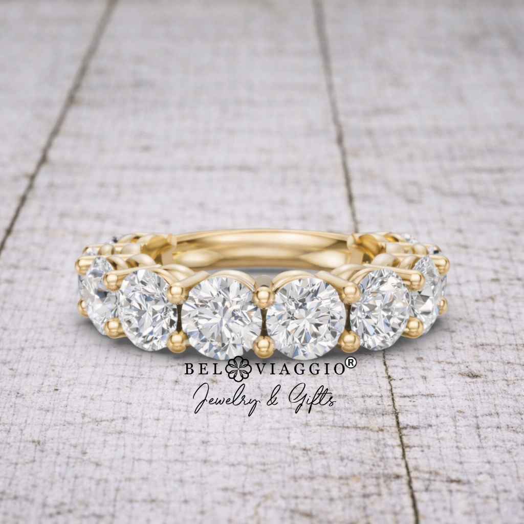Gold diamond eternity band with round brilliant stones on rustic wooden surface