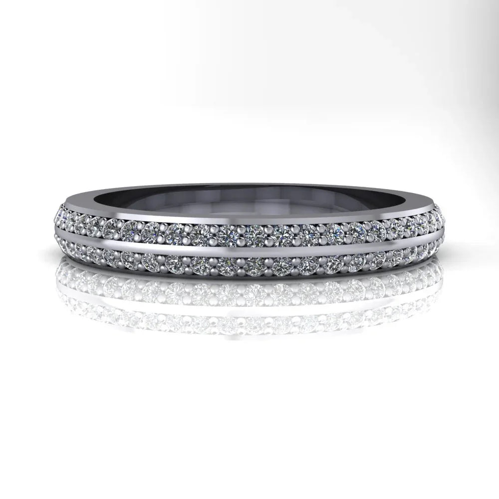 White gold diamond eternity band with double row pavé setting, reflected on white surface