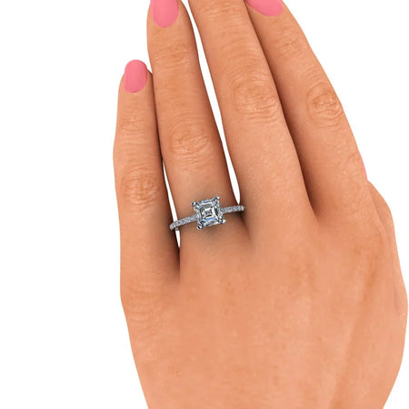 Square-cut diamond engagement ring with pavé band on hand, custom jewelry design
