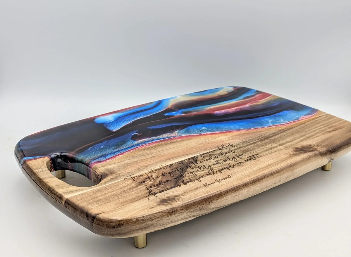 Handcrafted wood and resin serving board with engraved quote, blue and red swirl design, gold feet