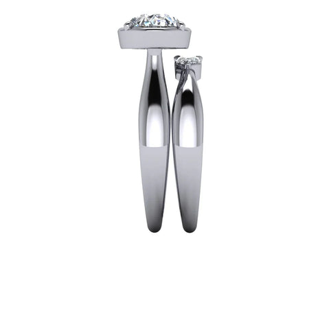 Side view of two white gold diamond engagement rings with solitaire settings on white background