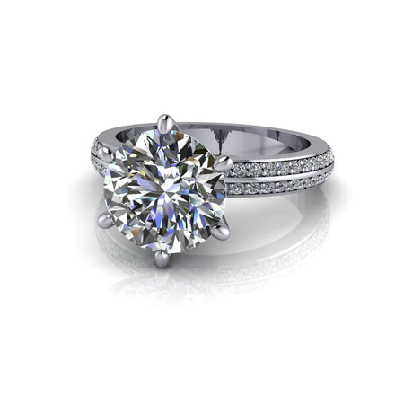 Round cut diamond engagement ring with pavé band in white gold on white background