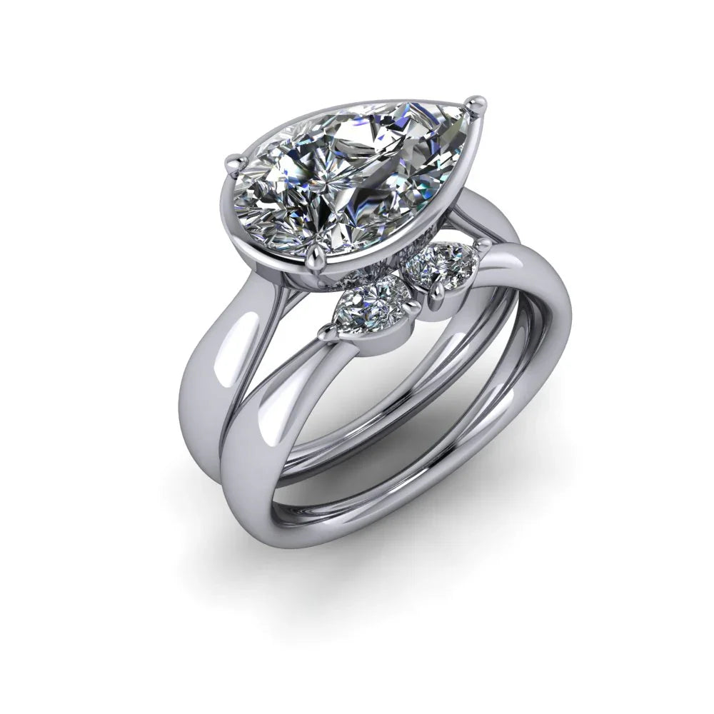 Pear-shaped diamond engagement ring set in white gold with accent stones