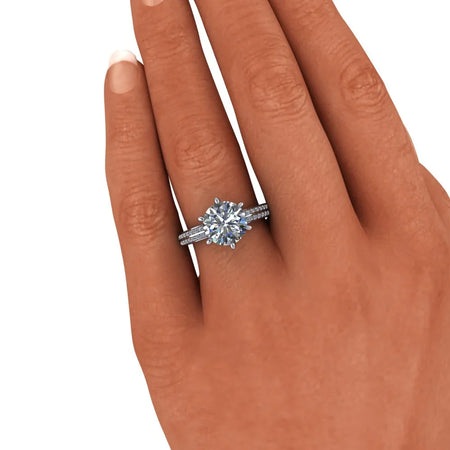 Hand wearing a custom round solitaire diamond engagement ring with pavé band