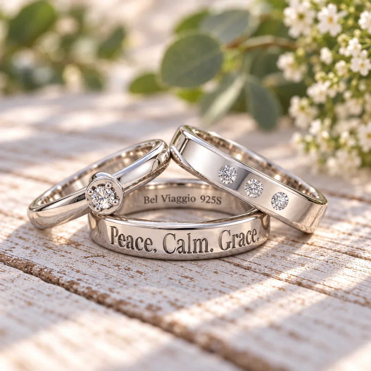 Custom silver wedding bands with diamond accents and engraved peace calm grace text.