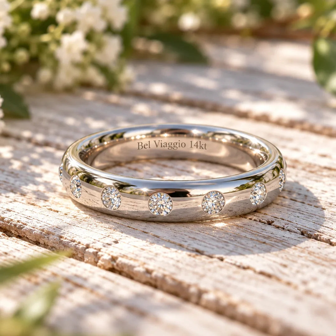Bel Viaggio Designs flush set 14kt gold wedding band with lab diamonds on a rustic wood surface