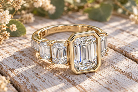 Bel Viaggio Designs 14kt gold graduated emerald cut lab diamond anniversary ring on rustic wood