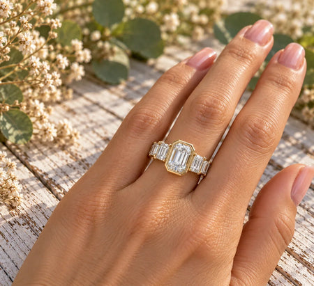 Bel Viaggio Designs graduated emerald cut lab diamond anniversary ring on a woman's hand