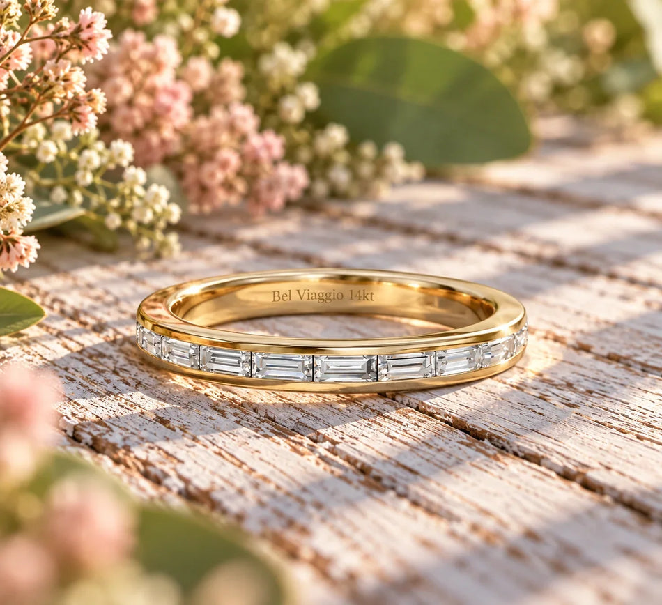 Bel Viaggio Designs lab diamond baguette wedding band in 14kt gold on a rustic wooden surface