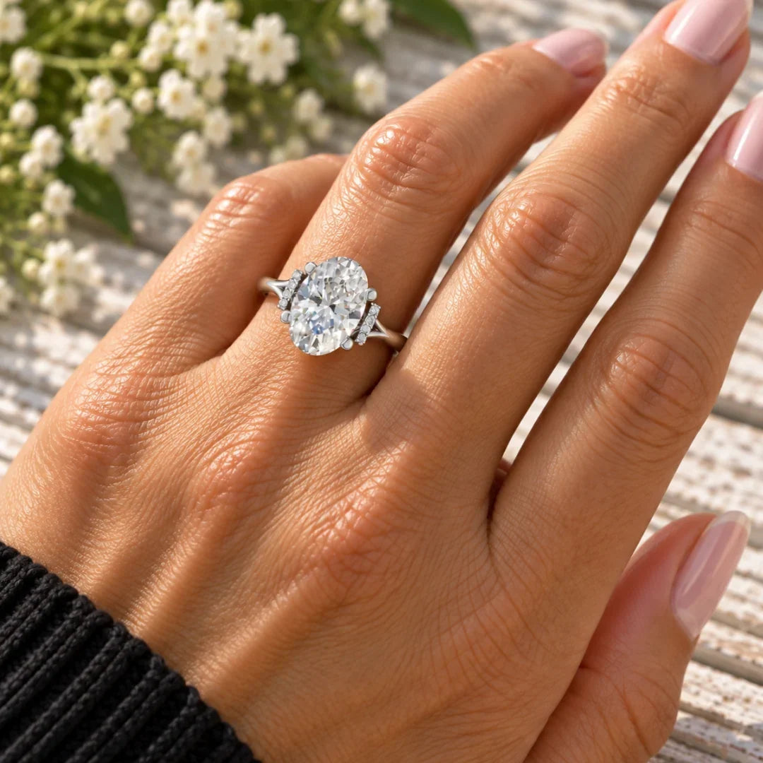Bel Viaggio Designs oval lab diamond engagement ring with split shank on a hand