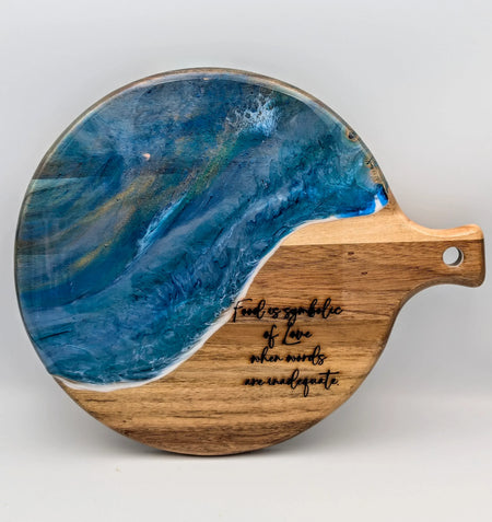 Round wooden serving board with blue resin ocean wave design and engraved quote, food gift idea