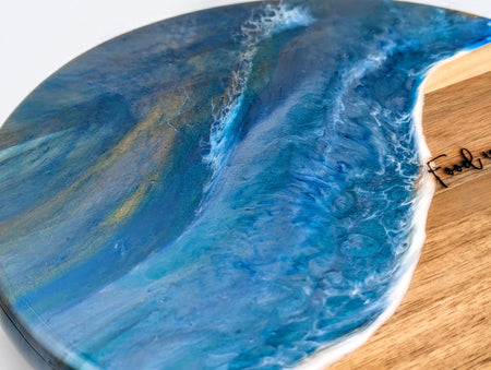 Handcrafted resin ocean art on wooden serving board with wave detail