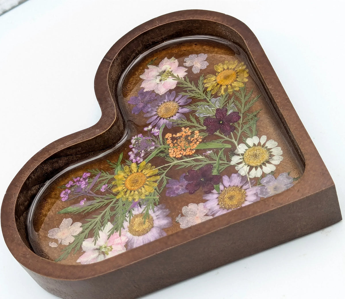 Heart-shaped resin jewelry tray with pressed dried flowers and dark wood border