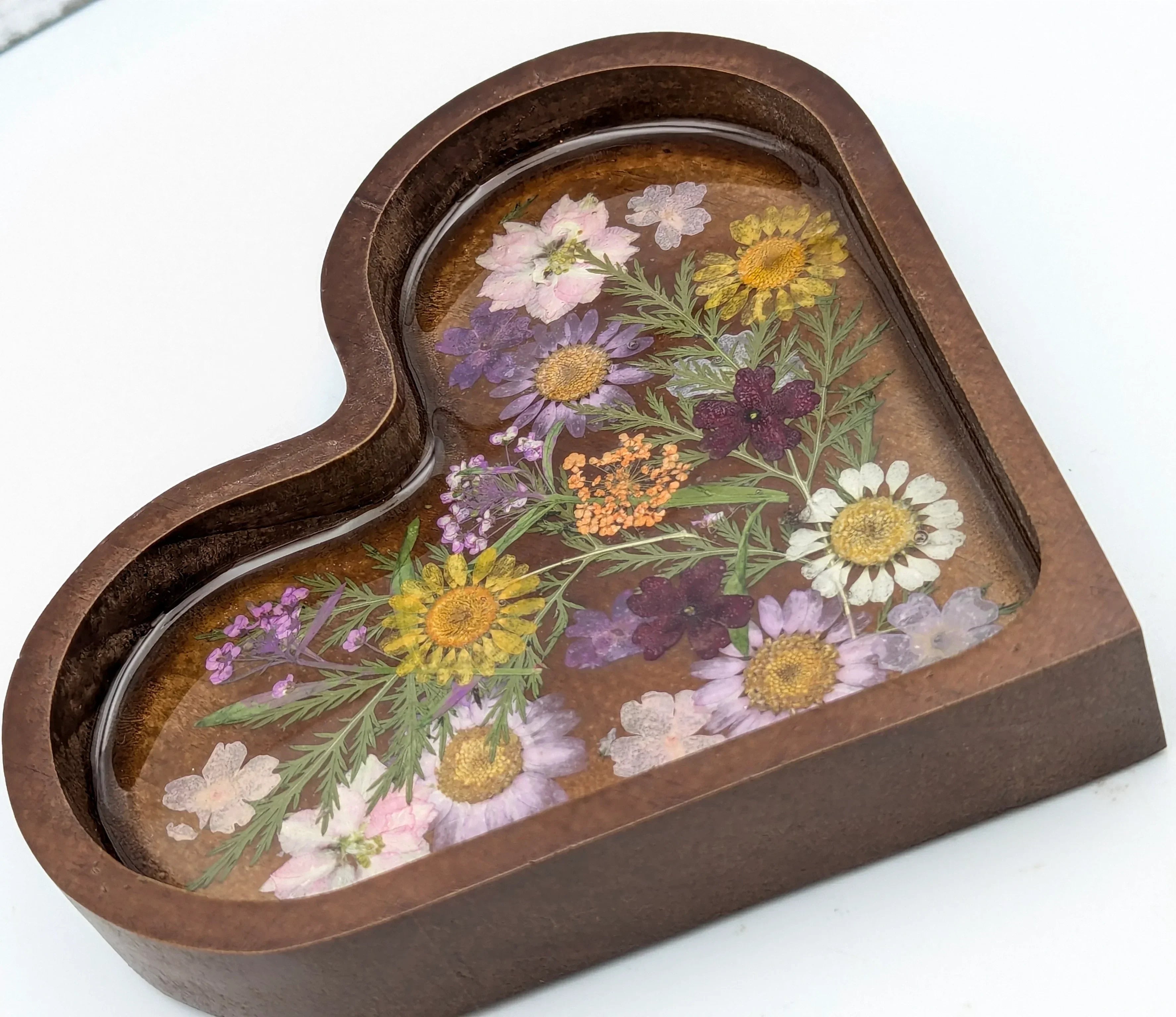Heart-shaped resin jewelry tray with pressed dried flowers and dark wood border