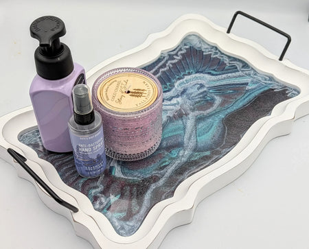 Decorative tray with lavender hand soap, antibacterial hand spray, and a pink candle