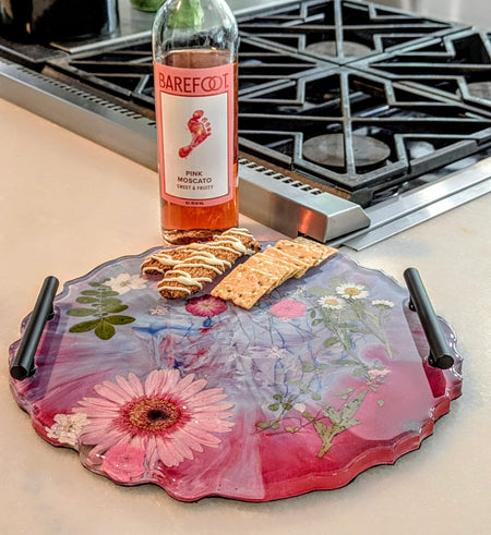 Floral resin tray with crackers and Barefoot Pink Moscato bottle on kitchen counter