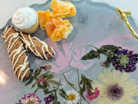 Floral resin tray with biscotti, cupcake, and dried fruit for elegant dessert presentation