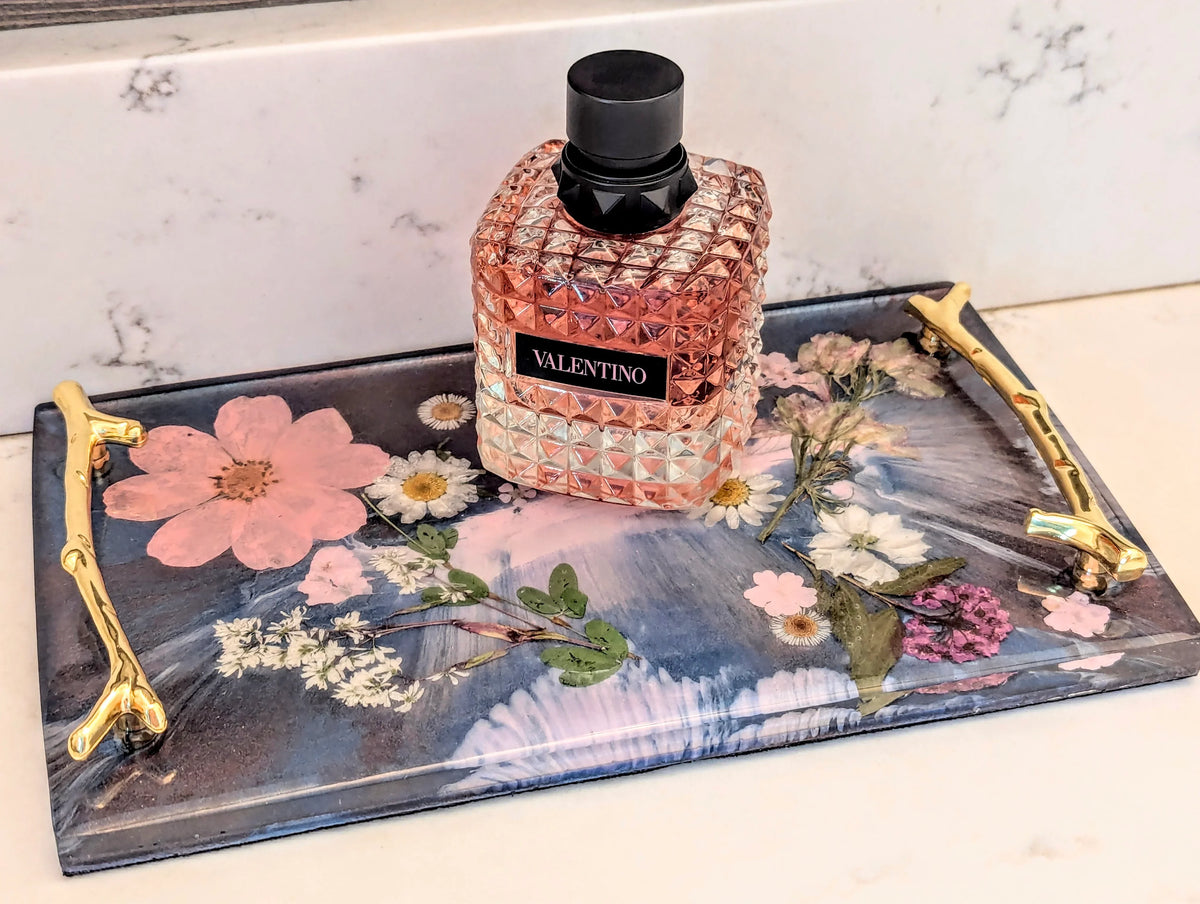 Stacy K Studio floral resin vanity tray with gold handles and a perfume bottle
