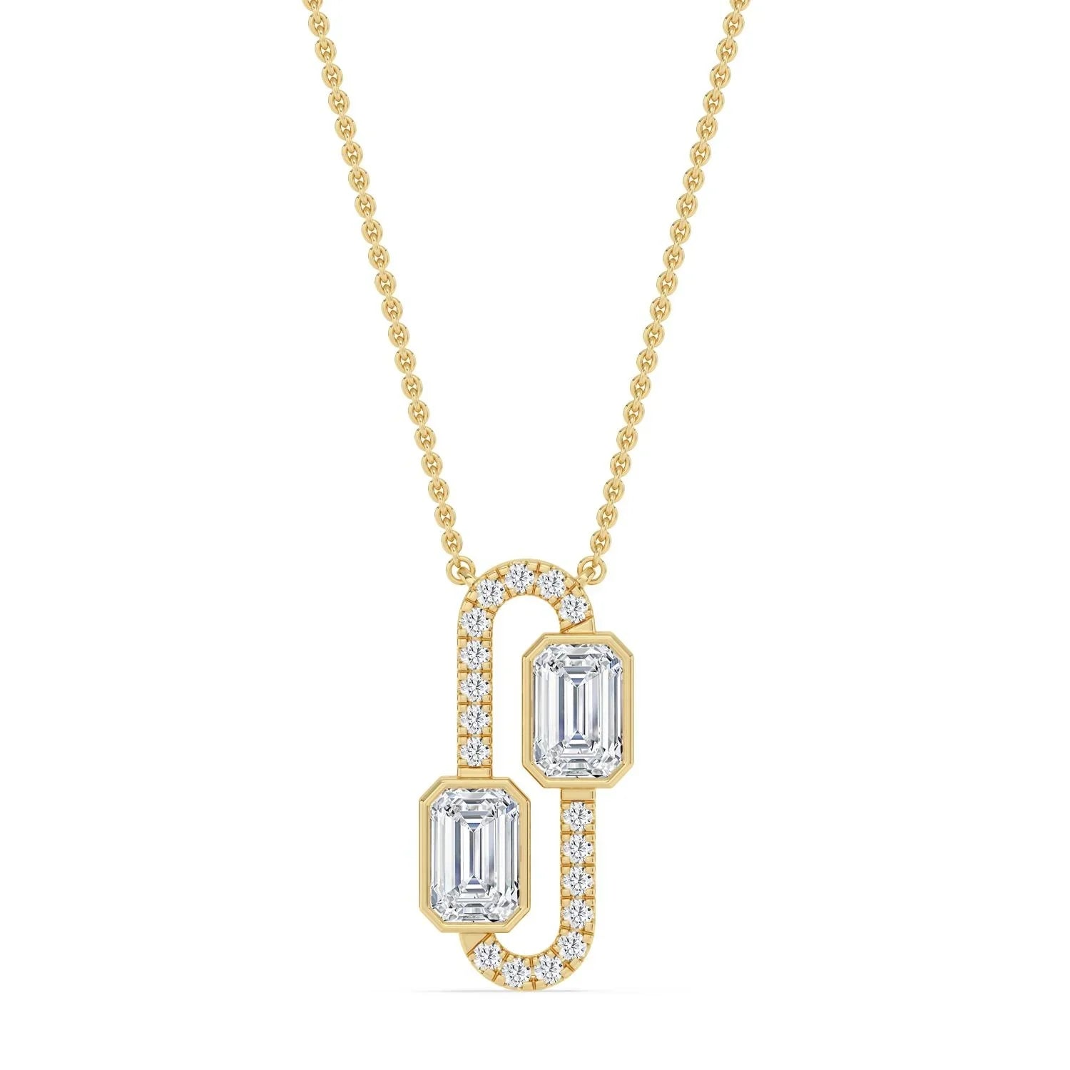 Elegant gold necklace with two emerald-cut diamonds and diamond accents, perfect for custom engagement jewelry.