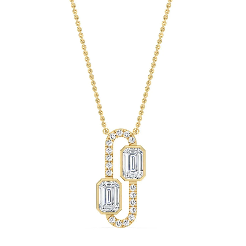 Elegant gold necklace with two emerald-cut diamonds and diamond accents, perfect for custom engagement jewelry.