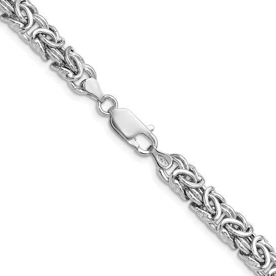 Close-up of a polished sterling silver Byzantine style link chain with a lobster claw clasp