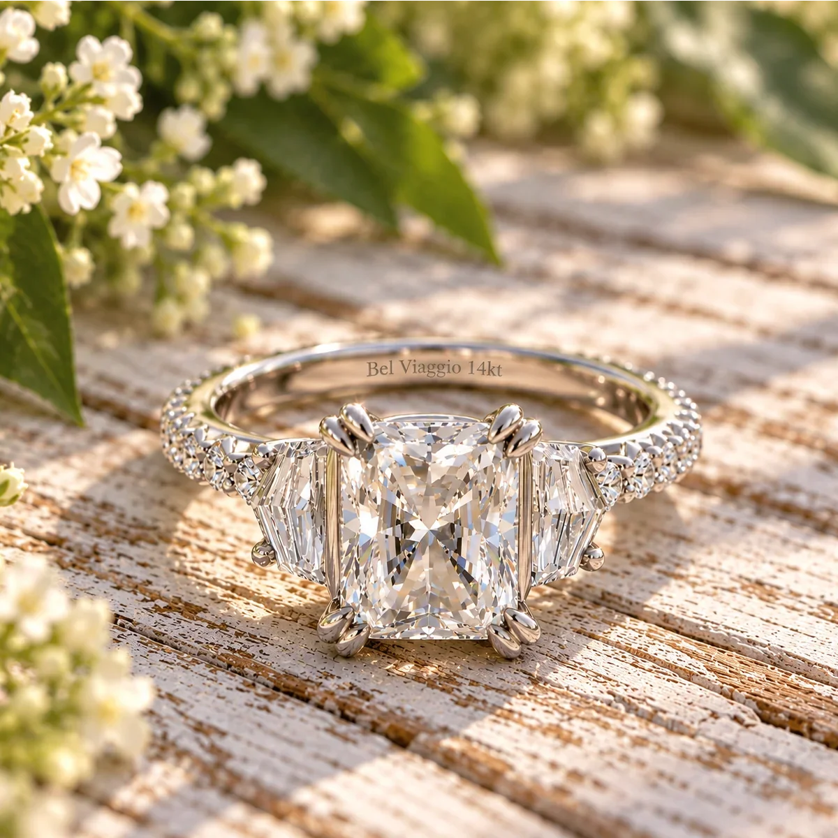 Bel Viaggio Designs lab diamond radiant and cadillac three stone ring on a wooden surface