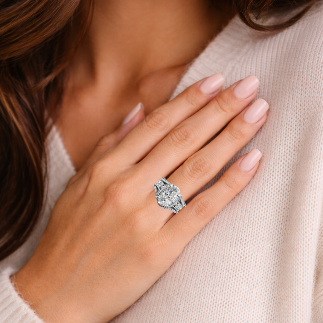 Woman wearing a custom diamond engagement ring with intricate setting on her hand