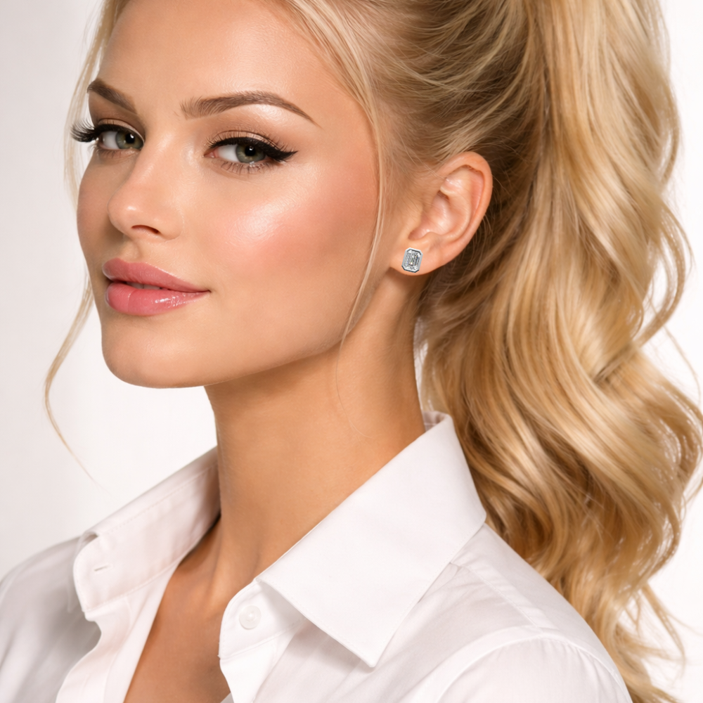 Woman wearing a white shirt and emerald-cut diamond stud earrings, custom jewelry
