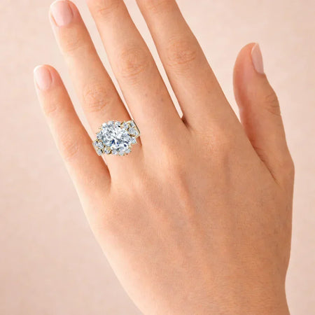Gold custom engagement ring with large oval-cut diamond on hand