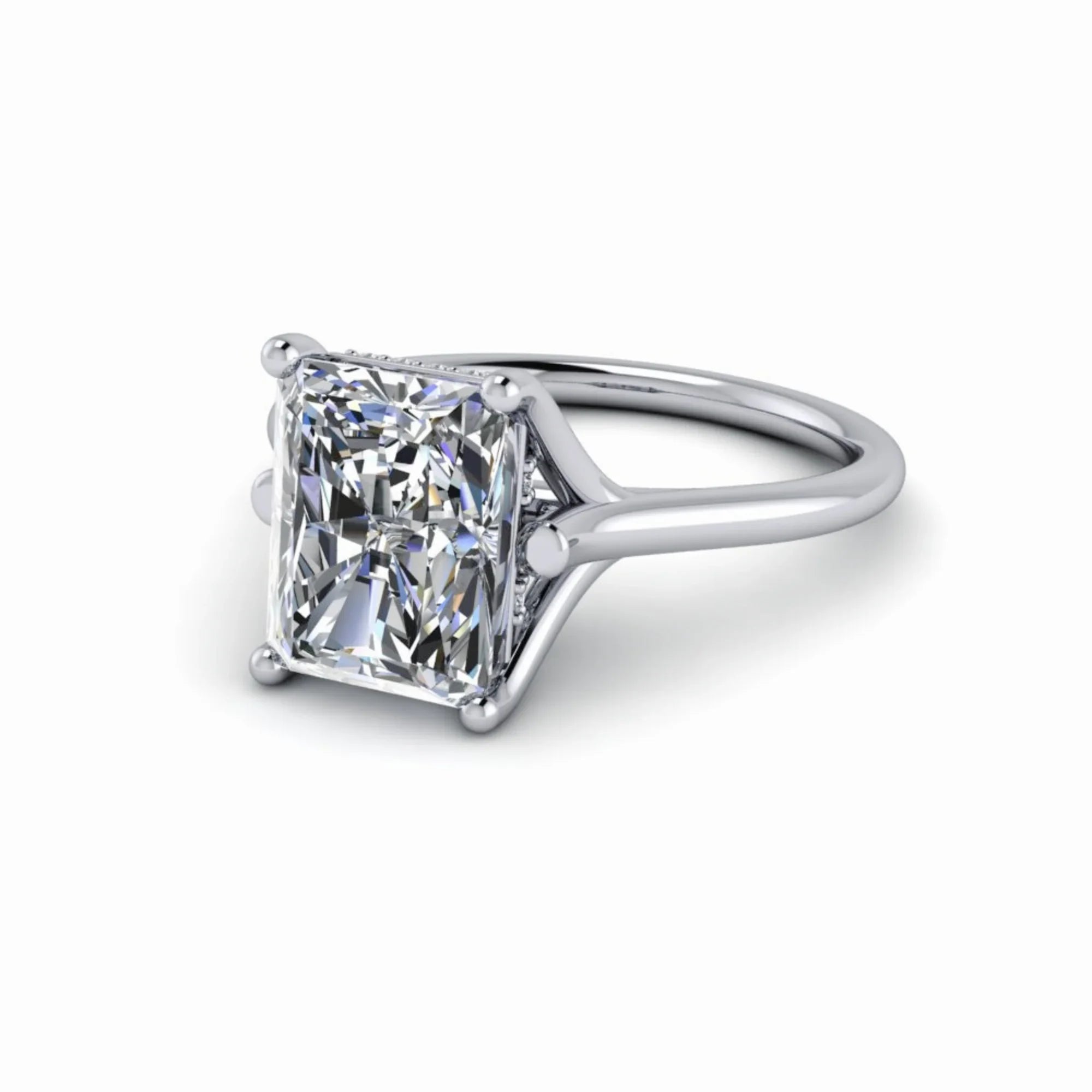 Radiant cut diamond solitaire engagement ring with prong setting on white gold band