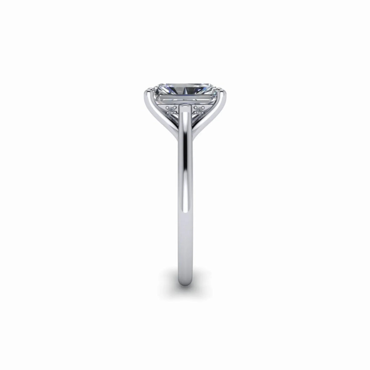 Side view of a solitaire diamond engagement ring with a thin white gold band